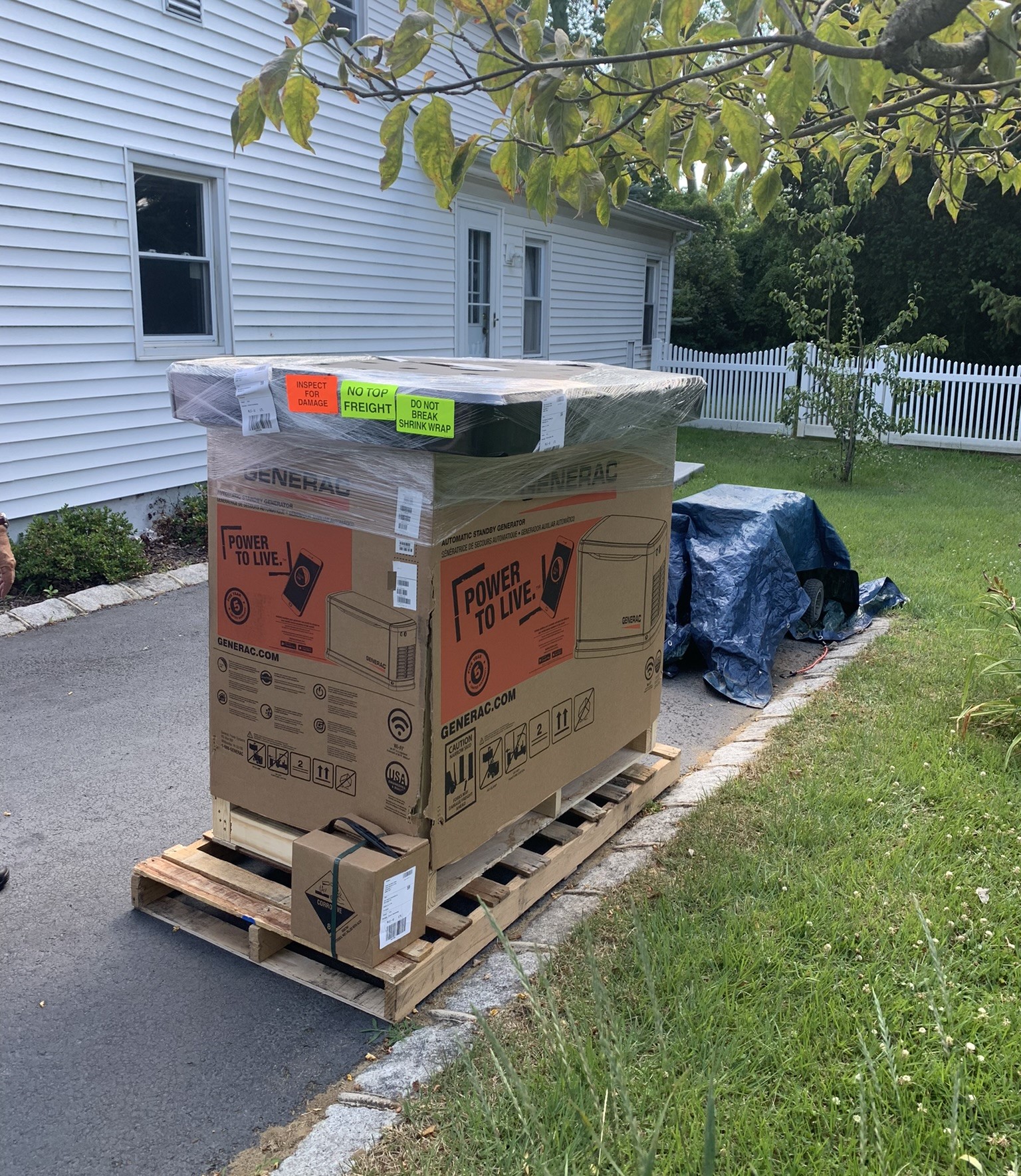 Delivery of generac generator product in box with supplies on driveway